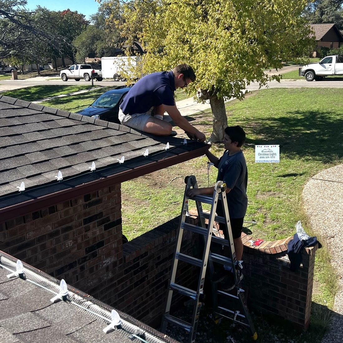 RiverHills Christmas Lights crew installing C9 bulbs along a roofline in Kerrville, Texas